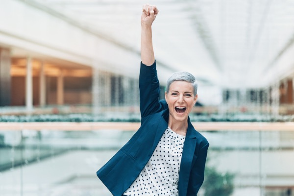 Happy woman with hand in the air